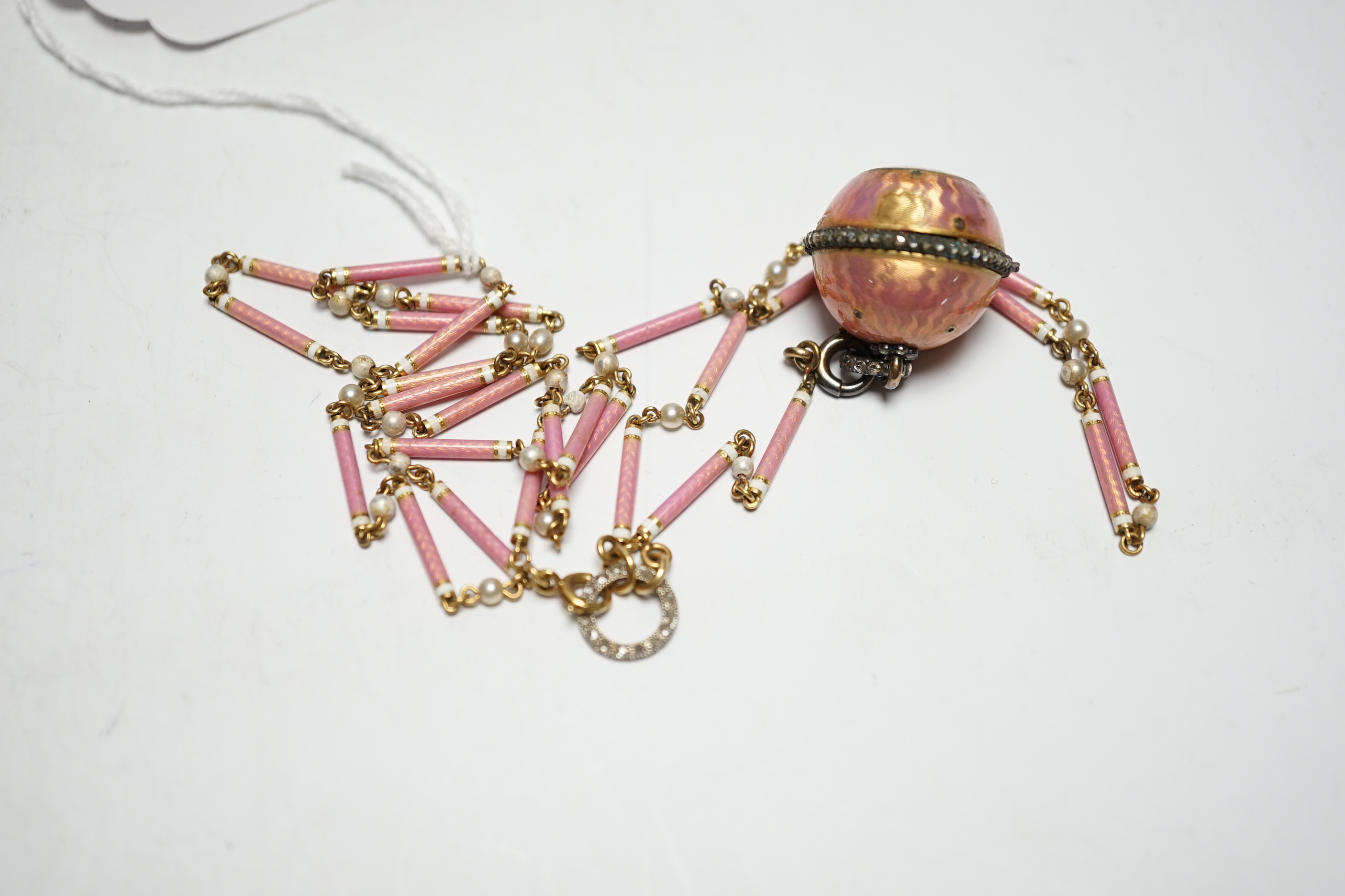 A lady's Swiss Belle Epoque yellow metal, rose cut diamond and enamelled globe watch, on a similar yellow metal rose cut diamond, two colour enamel and seed pearl set necklace, overall 84cm (a.f.).